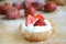 Muffin with fresh strawberries, white cream and powder