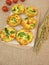Muffin frittatas with rice, carrots, broccoli and tomatoes