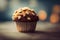 a muffin with nuts on top of it on a table with blurry background and light spots on it