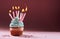 Muffin or a small cake with a burning candle. concept of congratulation, holiday.