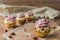 Muffin with strawberry foam and almonds on rustic wooden table