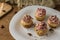 Muffin with strawberry foam and almonds on rustic wooden table