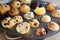 muffin tin filled with an assortment of scones and muffins for tea-time treats