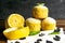 Muffins with lemon and mint on a white napkin on dark wooden table. Top views, close-up