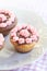 Muffins with pink cream and chocolate