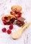 Muffins with raspberries, chocolate and oat bran on spoon, wooden background, delicious dessert