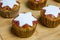 Muffins with red strawberry marmelade and white start placed on wooden board