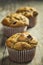 Muffins on rustic farm table.