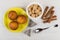 Muffins on saucer, teabags, sugar, cinnamon, teaspoon on table