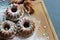 Muffins sprinkled with powdered sugar on a wooden background. Homemade cake.