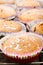 Muffins topped with powdery sugar on a wooden background