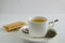 Mug with a bag of green tea. Against the background of cookies with sunflower seeds