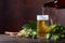 Mug of beer, grain and hops on a old wooden table.