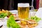 Mug of Beer on Table with Plated Food Dishes