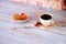 Mug of black coffee on a napkin with anise and a biscuit cake saucer