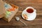 Mug of black tea, a bar of muesli and boxes with bars