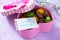 Mug cakes Macaron, leaf notebook inscription good morning on purple table top. The cozy breakfast.