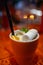 Mug with citrus and mashmelo hot drink on a bar counter. Shallow depth of field.