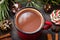 A mug of cocoa surrounded by Christmas decorations. Top view