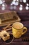 Mug of coffee, cookies, star anise, cinnamon, old books. Blurred lights, wooden background. Winter time, Rustic background