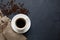 Mug of coffee, napkin and coffee beans on the kitchen table.