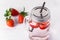 Mug of Delicious Refreshing Drink of Strawberry on White Wooden Background Infused Detox Water