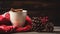 a mug filled with steaming hot drink adorned with marshmallows, with seasonal elements like a candle, cinnamon, anise