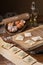 Mug flour, eggs, rolling pin, olive oil in a jar on a wooden background, making ravioli