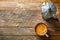 Mug with freshly brewed coffee with crema moka pot on aged wood kitchen table. Cozy homely atmosphere