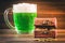 A mug of green beer on the table. Clover leaves. Chest of gold, coins pile. St.Patrick\'s Day.