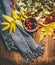 Mug of herbal tea with red autumn hawthorn berries , fall leaves and scarf on rustic wooden background