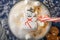 Mug with hot chocolate with melted snowman marshmallows and caramel. Close-up