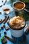 Mug with hot chocolate and whipped cream is decorated with ground cinnamon