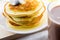 Mug of hot cocoa and pancakes with honey close-up