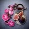 A mug of hot coffee, figs and flowers. A cosy evening. Spring, Autumn. Top view