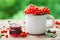 Mug of Red currant berries and jar of redcurrant jam