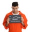 Mug shot of prisoner in orange jumpsuit with board on white background, front view