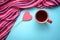 A mug of tea and a heart on a stick on a blue background
