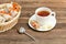 Mug of tea, muesli bars and tea strainer. Wicker basket with bar