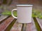 Mug on a wooden bench on a blurred background