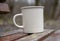 Mug on a wooden bench on a blurred background