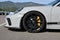 Mugello Circuit, Italy - 23 September 2021: detail of an alloy wheel rim with yellow brake caliper of a Porsche 911 in the paddock