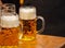 Mugs of beer on a wooden table, closeup view. Oktoberfest, Munich, Bavaria