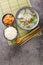 Muguk is an easy soup made with Korean radish and beef served with rice and kimchi closeup on the mat. Vertical top view