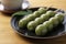 Mugwort-flavored rice dumpling and green tea on a wooden table