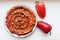 Muhammara, healthy walnut and roasted red bell pepper dip in a ceramic white plate