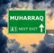 MUHARRAQ road sign against clear blue sky