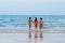 MUI NE, VIETNAM - MARCH 11, 2017: Three young lesbian girlfriends girls run along the beach to the ocean on summer