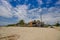 Muisne, Ecuador - March 16, 2016: Large beautiful untouched sandy beach by pacific ocean with small house construction