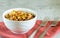 Mujadara: lentils, rice and fried onions on light background with red textiles